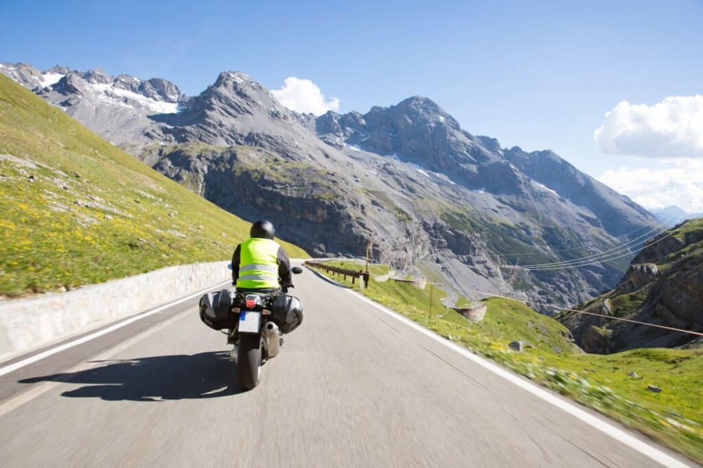 Motorrad Apps für Routenplanung – Biker auf kurviger Bergstraße in den Alpen